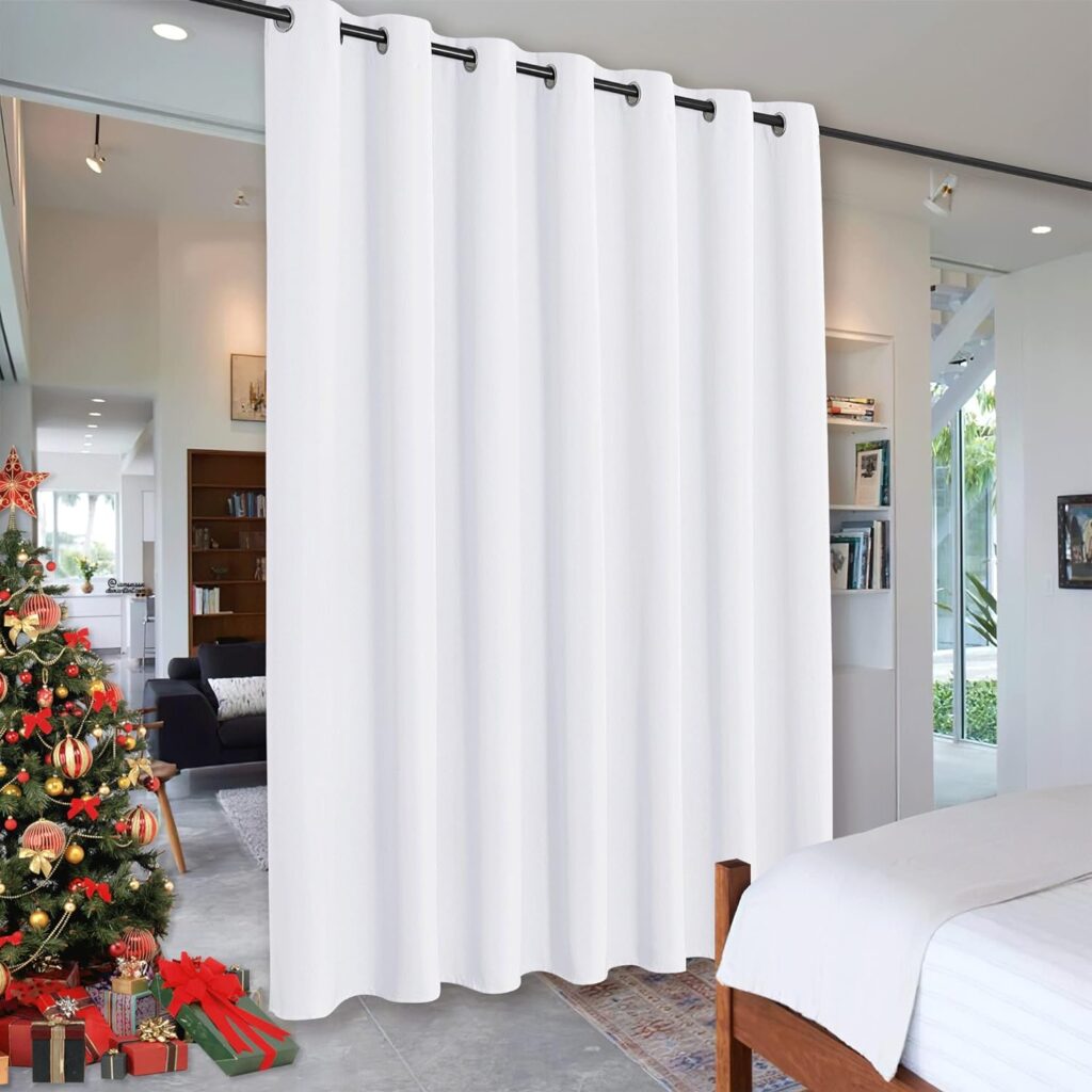 
White room divider curtains by RYB HOME, elegantly hung on a black rod, effectively separating a cozy bedroom from a well-decorated living room with a Christmas tree in the background. 