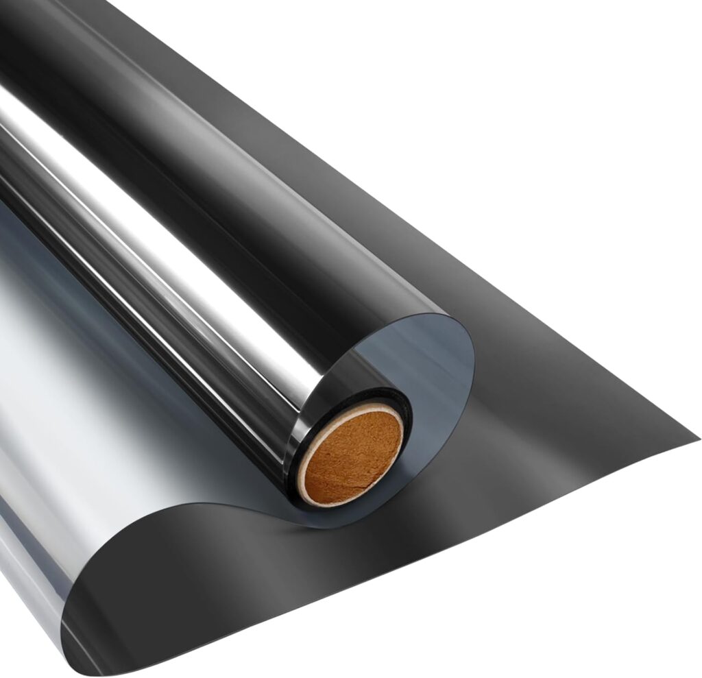 Roll of reflective window privacy film, showing a smooth, shiny surface that reflects light. The film is partially unrolled, revealing its dark, tinted appearance designed to enhance privacy and reduce glare. The inner cardboard tube is visible at the center of the roll.