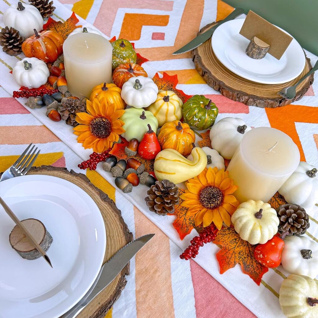 Cozy and well lit table with some candles and a lot of fall decor